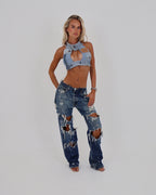 Le Pétite Jean distressed denim jeans with ripped and faded details, casual fit, and classic five-pocket design.
