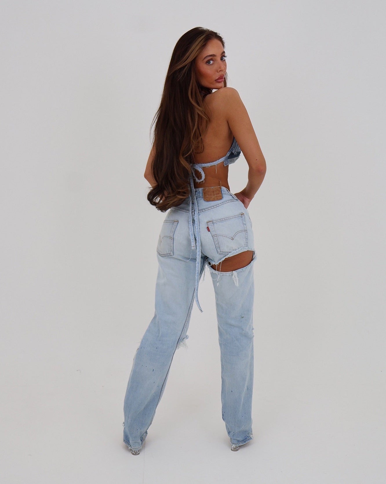 Le Pétite Jean Cheek Peek Denim showing the back view with detailed stitching and stylish fit on a model.